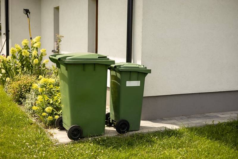 Two,Big,Empty,Green,Plastic,Trash,Garbage,Bin,In,Front