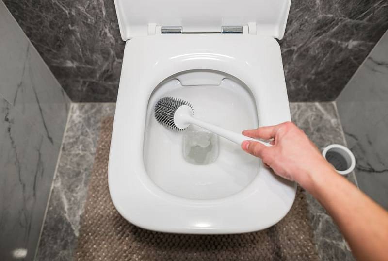 Washing,The,Toilet,With,A,Gray,Silicone,Sponge